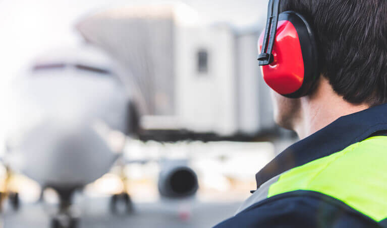 Airport worker wearing earmuffs
