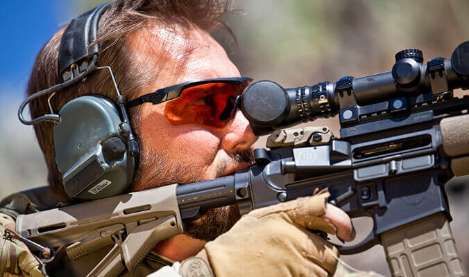 Soldier wearing ballistic-eyewear while aiming