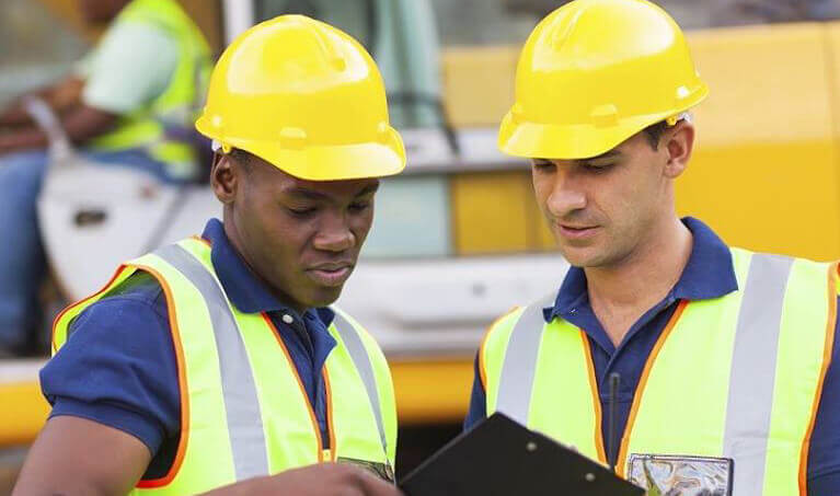 Construction workers wearing hard hats