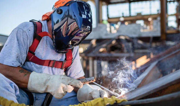 Worker wearing a Pyramex Leadhead WHAM30 welding helmet