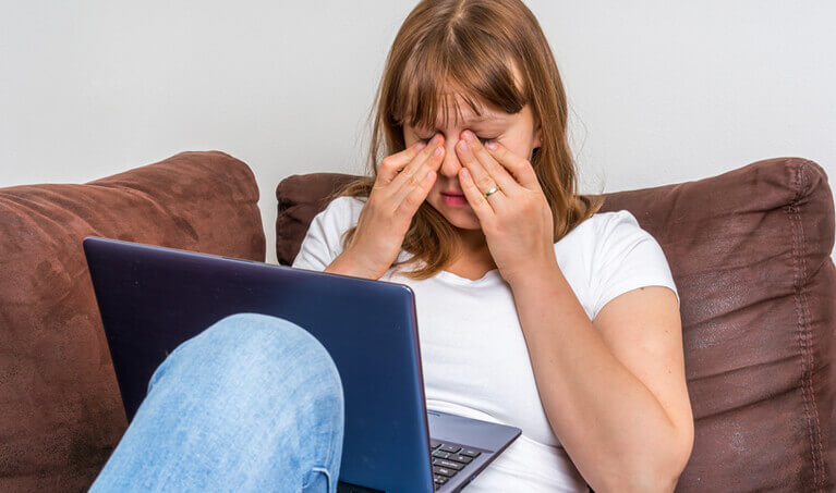 Woman rubbing her irritated eyes