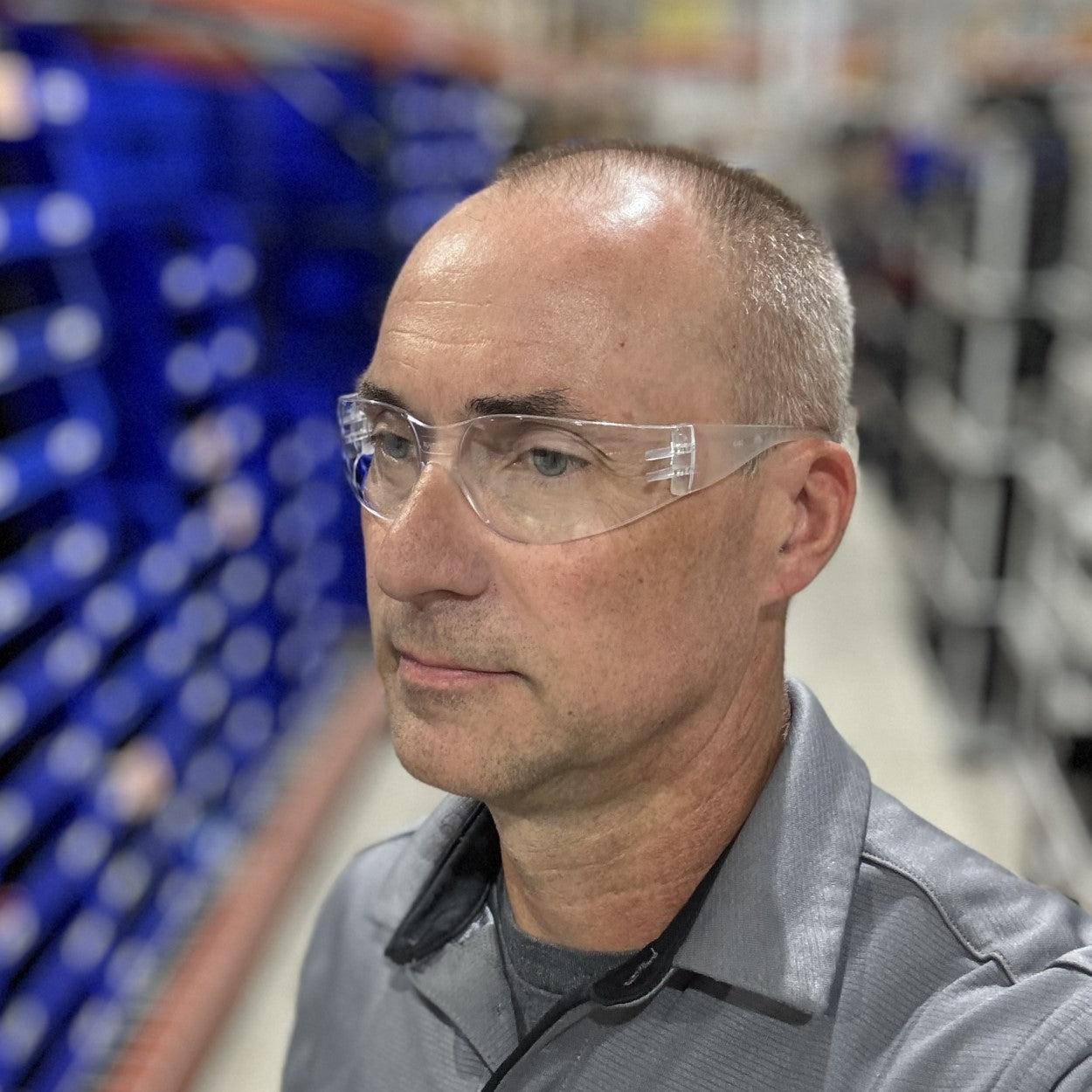 Pyramex Intruder Safety Glasses with Clear Lenses worn by warehouse worker