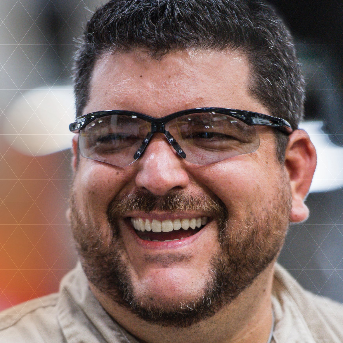 A smiling man wearing KleenGuard Nemesis Safety Glasses