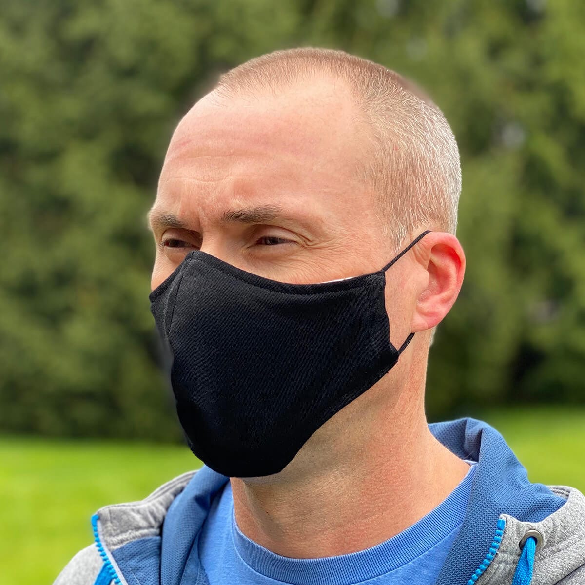 Cloth Face Mask Washable & Reusable 100% Cotton With Adjustable Ear Loops - being worn, 3/4 view